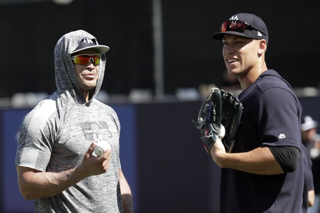 New York Yankees' Giancarlo Stanton, left, and Aaron Judge do drills at the Yankees spring training baseball facility, Thursday, Feb. 21, 2019, in Tampa, Fla. (AP Photo/Lynne Sladky)