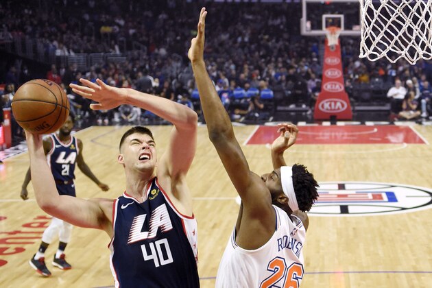 Los Angeles Clippers center Ivica Zubac, left, shoots as New York Knicks center Mitchell Robinson defends during the first half of an NBA basketball game Sunday, March 3, 2019, in Los Angeles. (AP Photo/Mark J. Terrill)