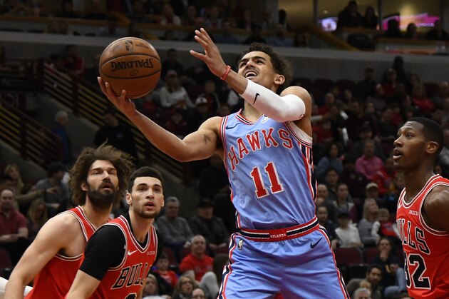 Atlanta Hawks guard Trae Young (11) shoots against Chicago Bulls guard Kris Dunn (32) during the first half of an NBA basketball game Sunday, March. 3, 2019, in Chicago. (AP Photo/Matt Marton)