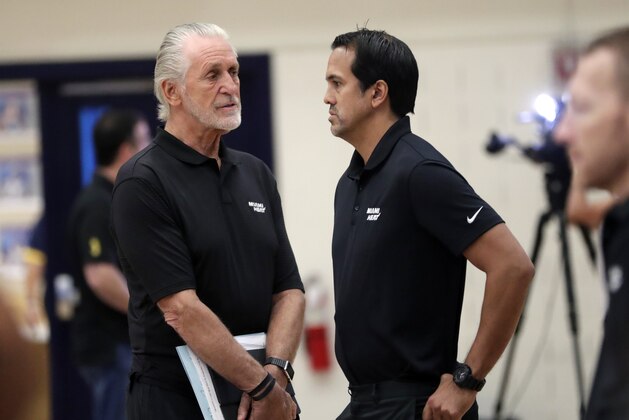 Miami Heat president Pat Riley, left, talks with head coach Erik Spoelstra during NBA basketball training camp, Wednesday, Sept. 26, 2018, in Boca Raton, Fla. (AP Photo/Lynne Sladky)