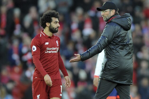 Liverpool manager Juergen Klopp, right, greets Liverpool's Mohamed Salah at the end of the English Premier League soccer match between Liverpool and AFC Bournemouth at Anfield stadium in Liverpool, England, Saturday, Feb. 9, 2019. (AP Photo/Rui Vieira)