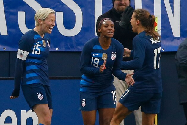 NASHVILLE, TN - MARCH 02:  Crystal Dunn #19 and Tobin Heath #17 congratulate teammate Megan Rapinoe #15 after scoring a goal against Englad during the first half of the 2019 SheBelieves Cup match between USA and England at Nissan Stadium on March 2, 2019 in Nashville, Tennessee.  (Photo by Frederick Breedon/Getty Images)