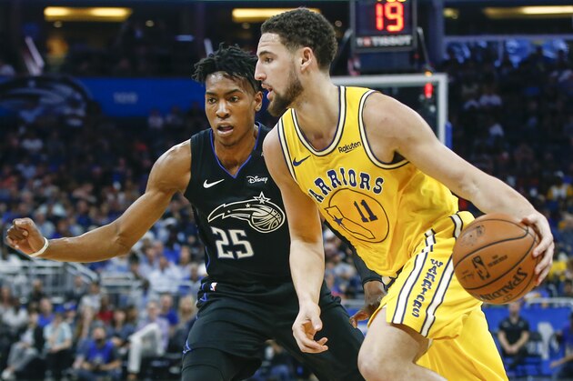 Golden State Warriors guard Klay Thompson (11) drives around Orlando Magic forward Wesley Iwundu (25) during the second quarter of an NBA basketball game in Orlando, Fla., on Thursday, Feb. 28, 2019. (AP Photo/Reinhold Matay)