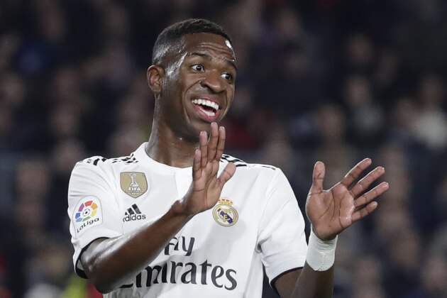 Real forward Vinicius Junior gestures after a misunderstanding with teammate Karim Benzema during the Copa del Rey semifinal first leg soccer match between FC Barcelona and Real Madrid at the Camp Nou stadium in Barcelona, Spain, Wednesday Feb. 6, 2019. (AP Photo/Emilio Morenatti)