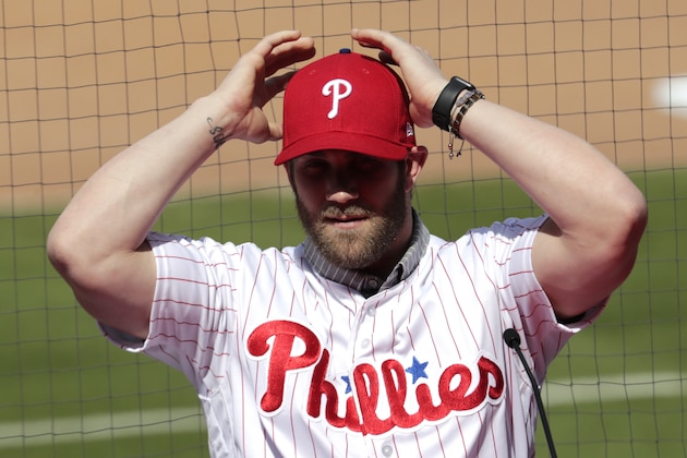 Bryce Harper adjust his cap as he introduced as a Philadelphia Phillies player during a news conference at the team's spring training baseball facility, Saturday, March 2, 2019, in Clearwater, Fla. Harper and the Phillies agreed to a $330 million, 13-year contract, the largest deal in baseball history. (AP Photo/Lynne Sladky)