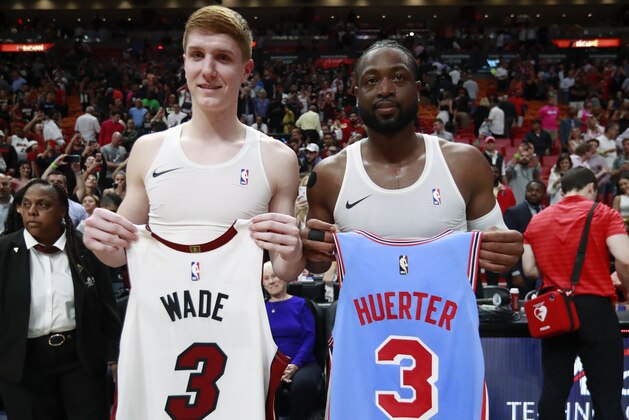 Miami Heat guard Dwyane Wade, right, and Atlanta Hawks guard Kevin Huerter swap jerseys after an NBA basketball game, Monday, March 4, 2019, in Miami.  (AP Photo/Wilfredo Lee)
