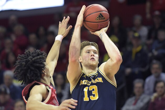 Michigan forward Ignas Brazdeikis (13) shoots as Rutgers guard Geo Baker defends during the second half of an NCAA college basketball game Tuesday, Feb. 5, 2019, in Piscataway, N.J. Michigan won 77-65. (AP Photo/Bill Kostroun)