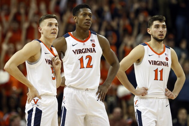 Virginia guard Kyle Guy (5) Virginia guard De'Andre Hunter (12) and Virginia guard Ty Jerome (11) watch a foul shot during the second half of an NCAA college basketball game in Charlottesville, Va., Tuesday, Jan. 22, 2019. Virginia defeated Wake Forest 68-45. (AP Photo/Steve Helber)