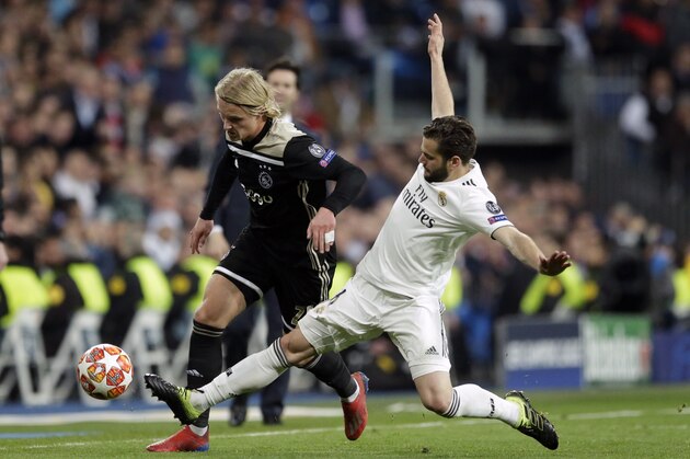Real defender Nacho Fernandez, right, tries to stop Ajax's Kasper Dolberg during the Champions League round of 16 second leg soccer match between Real Madrid and Ajax at the Santiago Bernabeu stadium in Madrid, Tuesday, March 5, 2019. (AP Photo/Bernat Armangue)
