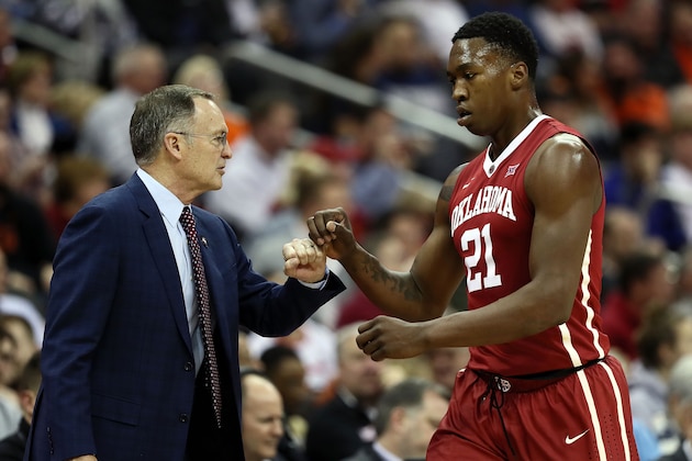 KANSAS CITY, MO - MARCH 07:  Head coach Lon Kruger of the Oklahoma Sooners fist bumps Kristian Doolittle #21 during the first round of the Big 12 Basketball Tournament against the Oklahoma State Cowboys at the Sprint Center on March 7, 2018 in Kansas City, Missouri.  (Photo by Jamie Squire/Getty Images)