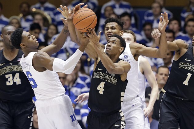 Duke's RJ Barrett (5) and Javin DeLaurier struggle for a rebound with Wake Forest's Torry Johnson (4) and Isaiah Mucius (1) during the second half of an NCAA college basketball game in Durham, N.C., Tuesday, March 5, 2019. Duke won 71-70. (AP Photo/Gerry Broome)