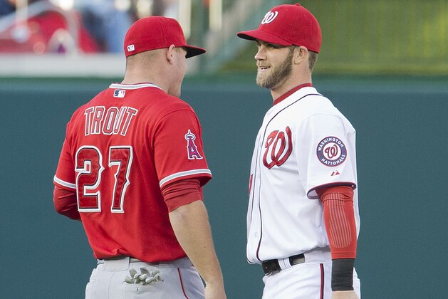 Los Angeles Angels Mike Trout, left, and Washington Nationals Bryce Harper, right, talk to each other during warm ups before the start of their baseball game, Wednesday, April 23, 2014 in Washington. (AP Photo/Pablo Martinez Monsivais)