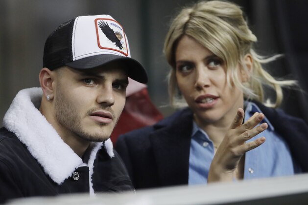 Inter Milan's Mauro Icardi is flanked by his wife Wanda Nara during the Europa League, round of 32, second leg soccer match between Inter Milan and SK Rapid Vienna, at the San Siro stadium in Milan, Italy, Thursday, Feb. 21, 2019. (AP Photo/Luca Bruno)