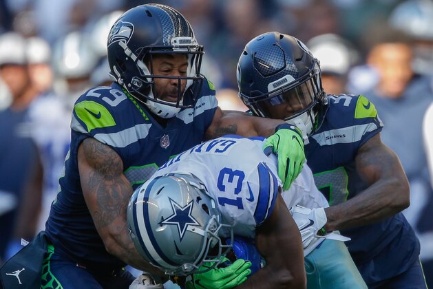 SEATTLE, WA - SEPTEMBER 23:  Wide receiver Michael Gallup #13 of the Dallas Cowboys is tackled by free safety Earl Thomas #29 and cornerback Tre Flowers #37 of the Seattle Seahawks at CenturyLink Field on September 23, 2018 in Seattle, Washington.  (Photo by Otto Greule Jr/Getty Images)