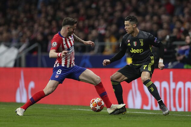 Atletico midfielder Saul Niguez, left, tries to stop Juventus forward Cristiano Ronaldo during the Champions League round of 16 first leg soccer match between Atletico Madrid and Juventus at Wanda Metropolitano stadium in Madrid, Wednesday, Feb. 20, 2019. (AP Photo/Manu Fernandez)