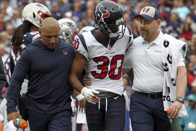 Houston Texans cornerback Kevin Johnson (30) is helped off the field after injuring his finger during the second half of an NFL football game against the New England Patriots, Sunday, Sept. 9, 2018, in Foxborough, Mass. (AP Photo/Stew Milne)