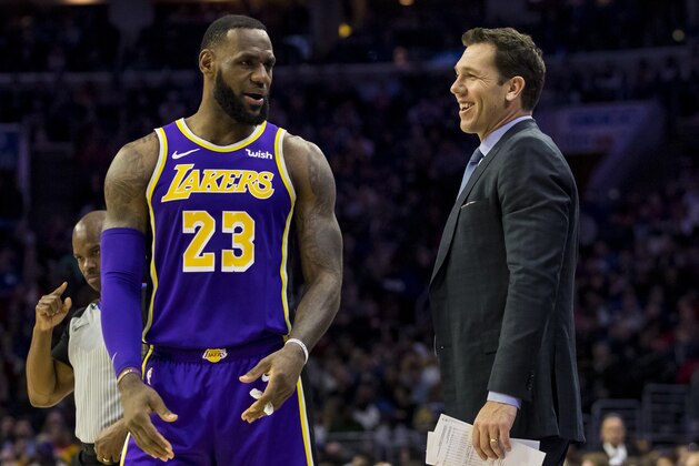 Los Angeles Lakers' head coach Luke Walton, right, talks things over with LeBron James, left, during the first half of an NBA basketball game against the Philadelphia 76ers, Sunday, Feb. 10, 2019, in Philadelphia. The 76ers won 143-120. (AP Photo/Chris Szagola)