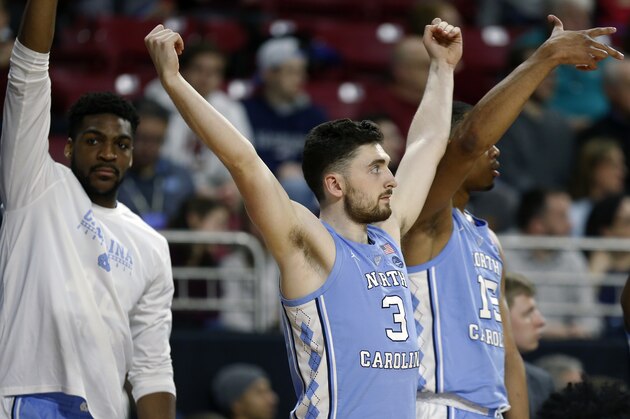 North Carolina's Andrew Platek (3) and Garrison Brooks (15) react on the bench during the first half of an NCAA college basketball game against Boston College in Boston, Tuesday, March 5, 2019. (AP Photo/Michael Dwyer)
