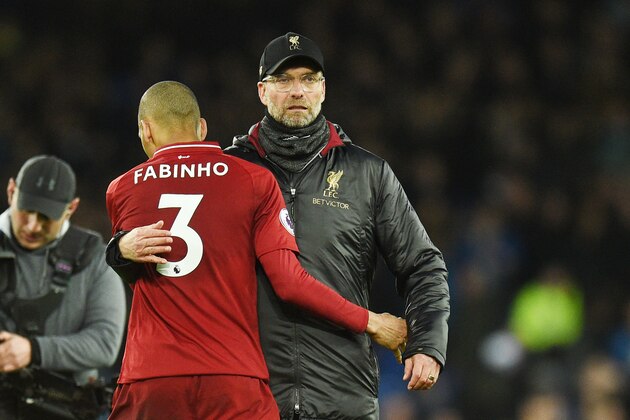 Liverpool's Brazilian midfielder Fabinho (L) is embraced by Liverpool's German manager Jurgen Klopp after drawing the English Premier League football match between Everton and Liverpool at Goodison Park in Liverpool, north west England on March 3, 2019. (Photo by Oli SCARFF / AFP) / RESTRICTED TO EDITORIAL USE. No use with unauthorized audio, video, data, fixture lists, club/league logos or 'live' services. Online in-match use limited to 120 images. An additional 40 images may be used in extra time. No video emulation. Social media in-match use limited to 120 images. An additional 40 images may be used in extra time. No use in betting publications, games or single club/league/player publications. /         (Photo credit should read OLI SCARFF/AFP/Getty Images)