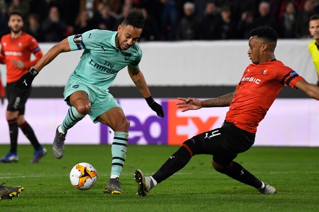 Arsenal's Gabonese striker Pierre-Emerick Aubameyang (L) vies with Rennes' Mozambican defender Mexer during the UEFA Europa League round of 16 first leg football match between Stade Rennais FC and Arsenal FC at the Roazhon Park stadium in Rennes, northwestern France on March 7, 2019. (Photo by DAMIEN MEYER / AFP)        (Photo credit should read DAMIEN MEYER/AFP/Getty Images)
