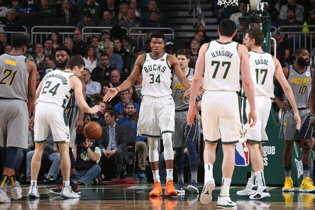 MILWAUKEE, WI - MARCH 7:  Giannis Antetokounmpo #34 of the Milwaukee Bucks hi-fives teammates during the game against the Indiana Pacers on March 7, 2019 at the Fiserv Forum Center in Milwaukee, Wisconsin. NOTE TO USER: User expressly acknowledges and agrees that, by downloading and or using this Photograph, user is consenting to the terms and conditions of the Getty Images License Agreement. Mandatory Copyright Notice: Copyright 2019 NBAE (Photo by Gary Dineen/NBAE via Getty Images).