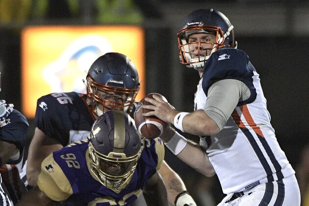 Orlando Apollos quarterback Garrett Gilbert, right, sets up to throw a pass in front of Atlanta Legends linebacker KeShun Freeman (92) during the first half of an Alliance of American Football game Saturday, Feb. 9, 2019, in Orlando, Fla. (AP Photo/Phelan M. Ebenhack)