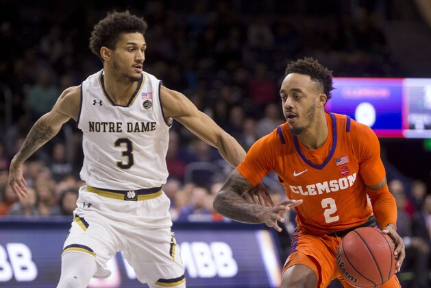 Clemson's Marcquise Reed (2) moves by Notre Dame's Prentiss Hubb (3) during the first half of an NCAA college basketball game Wednesday, March 6, 2019, in South Bend, Ind. (AP Photo/Robert Franklin)