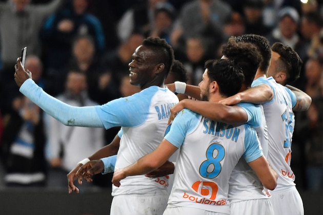 Marseille's Italian forward Mario Balotelli (L) takes a selfie with teammates after scoring during the French L1 football match between Olympique de Marseille and AS Saint-Etienne at the Velodrome Stadium in Marseille, southern France on March 3, 2019. (Photo by GERARD JULIEN / AFP)        (Photo credit should read GERARD JULIEN/AFP/Getty Images)