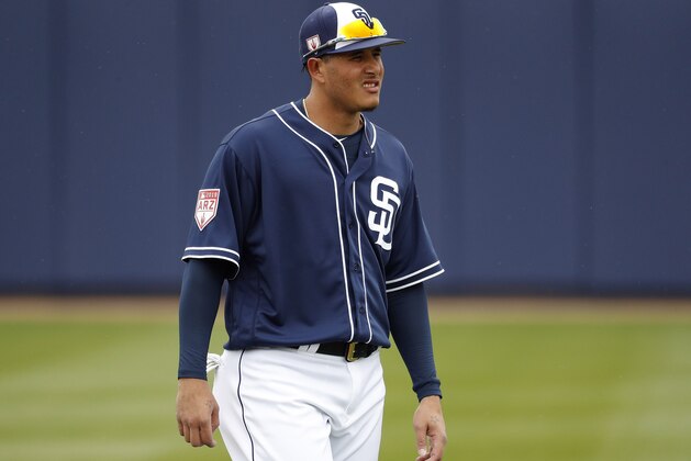 San Diego Padres' Manny Machado warms up prior to his first spring training baseball game of the season against the San Francisco Giants, Saturday, March 2, 2019, in Peoria, Ariz. (AP Photo/Matt York)