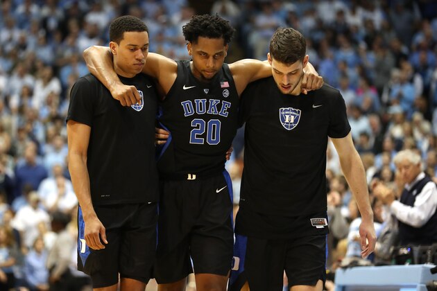 CHAPEL HILL, NORTH CAROLINA - MARCH 09: Marques Bolden #20 of the Duke Blue Devils is helped off the floor by teammates after an injury during their game against the North Carolina Tar Heels at Dean Smith Center on March 09, 2019 in Chapel Hill, North Carolina. (Photo by Streeter Lecka/Getty Images)