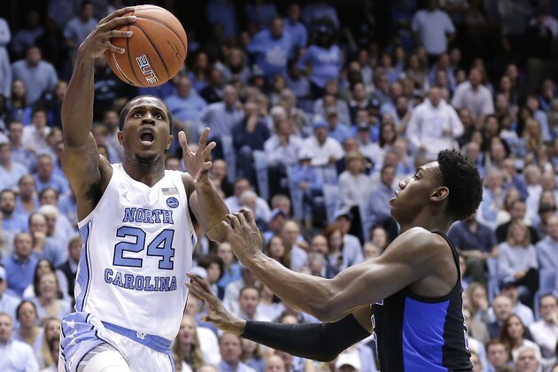 North Carolina's Kenny Williams (24) drives to the basket as Duke's RJ Barrett defends during the first half of an NCAA college basketball game in Chapel Hill, N.C., Saturday, March 9, 2019. (AP Photo/Gerry Broome)