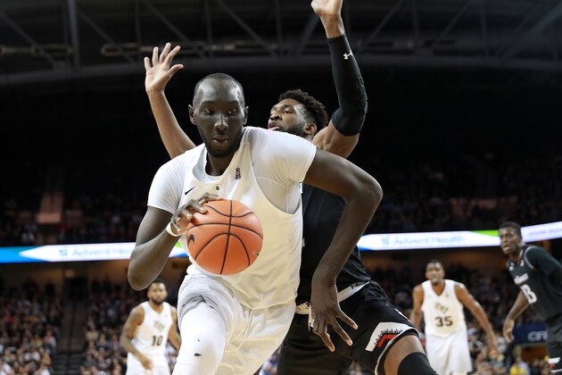 ORLANDO, FL - MARCH 07:  Tacko Fall #24 of the UCF Knights drives past Eliel Nsoseme #22 of the Cincinnati Bearcats during an NCAA basketball game at the CFE Arena on March 7, 2019 in Orlando, Florida. (Photo by Alex Menendez/Getty Images)