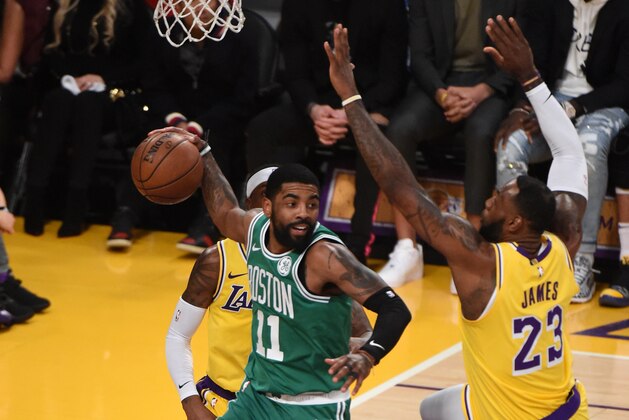 LOS ANGELES, CA - MARCH 9: Kyrie Irving #11 of the Boston Celtics looks to pass against LeBron James #23 of the Los Angeles Lakers on March 9, 2019 at STAPLES Center in Los Angeles, California. NOTE TO USER: User expressly acknowledges and agrees that, by downloading and/or using this Photograph, user is consenting to the terms and conditions of the Getty Images License Agreement. Mandatory Copyright Notice: Copyright 2019 NBAE (Photo by Adam PantozziNBAE via Getty Images)