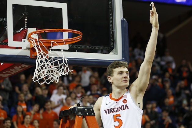 Virginia guard Kyle Guy (5) holds a piece of the net after his team defeated Louisville in Charlottesville, Va., Saturday, March 9, 2019. Virginia defeated Louisville 73-68. (AP Photo/Steve Helber)