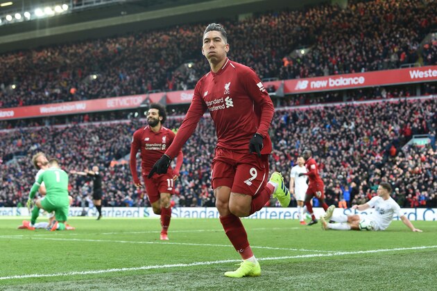 Liverpool's Brazilian midfielder Roberto Firmino (C) celebrates scoring their third goal during the English Premier League football match between Liverpool and Burnley at Anfield in Liverpool, north west England on March 10, 2019. (Photo by Paul ELLIS / AFP) / RESTRICTED TO EDITORIAL USE. No use with unauthorized audio, video, data, fixture lists, club/league logos or 'live' services. Online in-match use limited to 120 images. An additional 40 images may be used in extra time. No video emulation. Social media in-match use limited to 120 images. An additional 40 images may be used in extra time. No use in betting publications, games or single club/league/player publications. /         (Photo credit should read PAUL ELLIS/AFP/Getty Images)