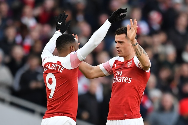 Arsenal's Swiss midfielder Granit Xhaka (R) celebrates scoring the opening goal with Arsenal's French striker Alexandre Lacazette (L) during the English Premier League football match between Arsenal and Manchester United at the Emirates Stadium in London on March 10, 2019. (Photo by Ben STANSALL / AFP) / RESTRICTED TO EDITORIAL USE. No use with unauthorized audio, video, data, fixture lists, club/league logos or 'live' services. Online in-match use limited to 120 images. An additional 40 images may be used in extra time. No video emulation. Social media in-match use limited to 120 images. An additional 40 images may be used in extra time. No use in betting publications, games or single club/league/player publications. /         (Photo credit should read BEN STANSALL/AFP/Getty Images)