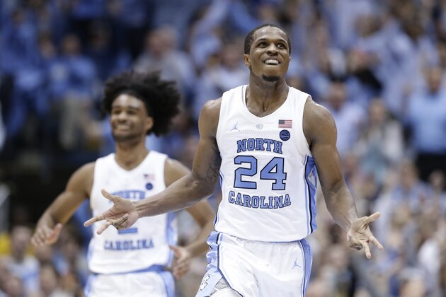 North Carolina's Kenny Williams (24) and Coby White react following a play against Duke during the second half of an NCAA college basketball game in Chapel Hill, N.C., Saturday, March 9, 2019. North Carolina won 79-70. (AP Photo/Gerry Broome)