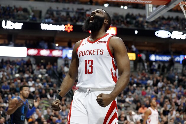 Houston Rockets guard James Harden (13) celebrates after sinking a basket and being fouled by Dallas Mavericks' Jalen Brunson, left rear, in the first half of an NBA basketball game in Dallas, Sunday, March 10, 2019. (AP Photo/Tony Gutierrez)