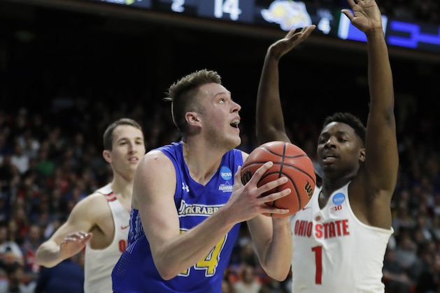 FILE - In this March 15, 2018, file photo, South Dakota State forward Mike Daum, left, puts up a shot against Ohio State forward Jae'Sean Tate, right, during the first half of a first-round game in the NCAA college basketball tournament, in Boise, Idaho. Daum was one of only three Division I players to average over 20 points and 10 rebounds last season. (AP Photo/Ted S. Warren, File)