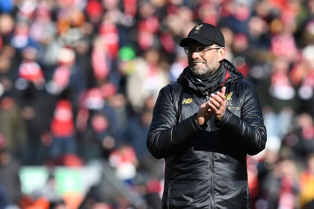 Liverpool's German manager Jurgen Klopp applauds on the pitch after the English Premier League football match between Liverpool and Burnley at Anfield in Liverpool, north west England on March 10, 2019. (Photo by Paul ELLIS / AFP) / RESTRICTED TO EDITORIAL USE. No use with unauthorized audio, video, data, fixture lists, club/league logos or 'live' services. Online in-match use limited to 120 images. An additional 40 images may be used in extra time. No video emulation. Social media in-match use limited to 120 images. An additional 40 images may be used in extra time. No use in betting publications, games or single club/league/player publications. /         (Photo credit should read PAUL ELLIS/AFP/Getty Images)