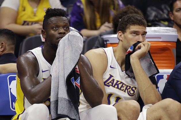 Los Angeles Lakers' Julius Randle, left, and Brook Lopez watch the closing moments of the Lakers 113-102 loss to the Sacramento Kings in an NBA basketball game Wednesday, Nov. 22, 2017, in Sacramento, Calif. (AP Photo/Rich Pedroncelli)