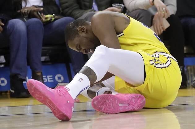 Golden State Warriors forward Kevin Durant reacts after injuring his ankle during the second half of an NBA basketball game against the Phoenix Suns in Oakland, Calif., Sunday, March 10, 2019. (AP Photo/Jeff Chiu)