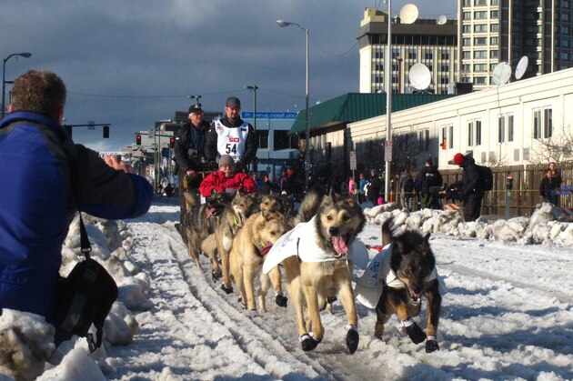 FILE - In this March 7, 2015, file photo, musher Peter Kaiser, of Bethel, Alaska, leads his team past spectators during the ceremonial start of the Iditarod Trail Sled Dog Race, in Anchorage, Alaska. There's a new leader in the Iditarod Trail Sled Dog Race after the dogs on musher Nicolas Petit's team quit on him. Alaska musher Pete Kaiser passed Petit and was the first musher to reach the checkpoint in Koyuk Monday, March 11, 2019. (AP Photo/Rachel D'Oro, File)