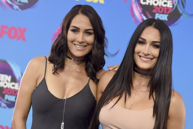 Brie Bella, left, and Nikki Bella arrive at the Teen Choice Awards at the Galen Center on Sunday, Aug. 13, 2017, in Los Angeles. (Photo by Jordan Strauss/Invision/AP)