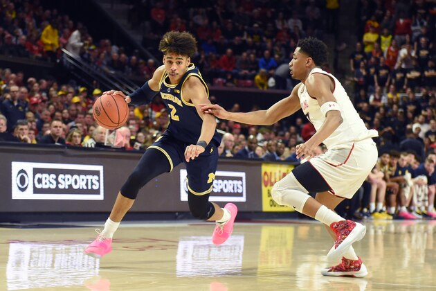 COLLEGE PARK, MD - MARCH 03:  Jordan Poole #2 of the Michigan Wolverines dribbles by Aaron Wiggins #2 of the Maryland Terrapins in the first half during a college basketball game at the XFinity Center on March 3, 2019 in College Park, Maryland.  (Photo by Mitchell Layton/Getty Images)