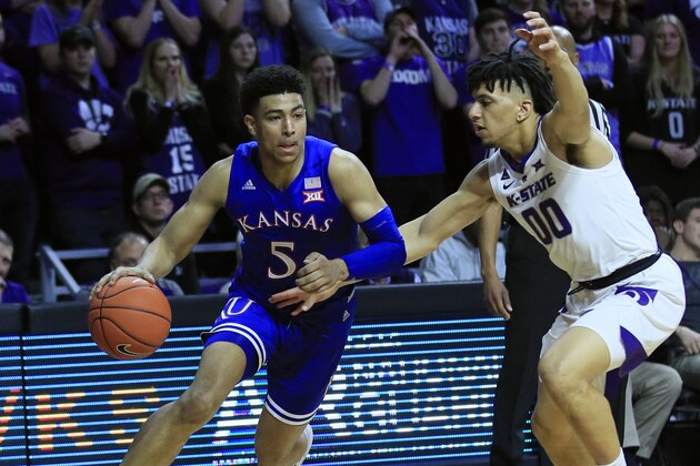 Kansas guard Quentin Grimes (5) and Kansas State guard Mike McGuirl (00) during the first half of an NCAA college basketball game in Manhattan, Kan., Tuesday, Feb. 5, 2019. (AP Photo/Orlin Wagner)