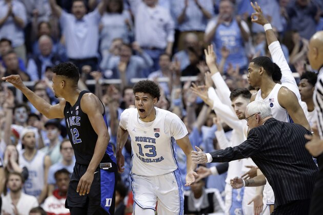North Carolina coach Roy Williams reaches for Cameron Johnson (13) following Johnson's basket against Duke while Duke's Javin DeLaurier (12) looks back during the second half of an NCAA college basketball game in Chapel Hill, N.C., Saturday, March 9, 2019. North Carolina won 79-70. (AP Photo/Gerry Broome)