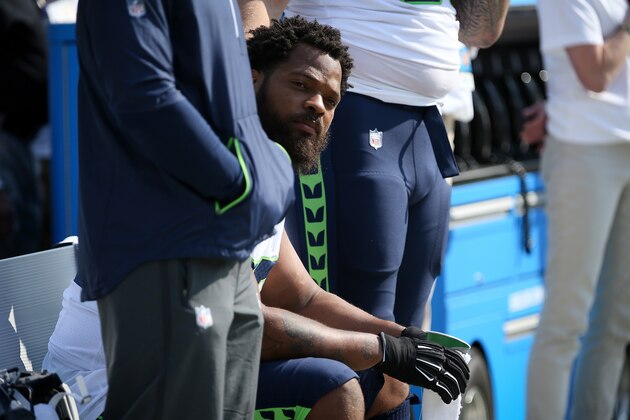 GREEN BAY, WI - SEPTEMBER 10:  Michael Bennett #72 of the Seattle Seahawks sits on the bench during the national anthem prior to the game against the Green Bay Packers at Lambeau Field on September 10, 2017 in Green Bay, Wisconsin. Bennett was controversially detained by the Las Vegas Metropolitan Police Department on August 27, after the Floyd Mayweather-Conor McGregor UFC fight. ( (Photo by Dylan Buell/Getty Images)