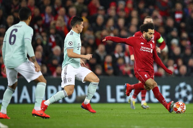 LIVERPOOL, ENGLAND - FEBRUARY 19:Mohamed Salah of Liverpool is watched by James Rodriguez of Bayern Munich during the UEFA Champions League Round of 16 First Leg match between Liverpool and FC Bayern Muenchen at Anfield on February 19, 2019 in Liverpool, England. (Photo by Clive Brunskill/Getty Images)