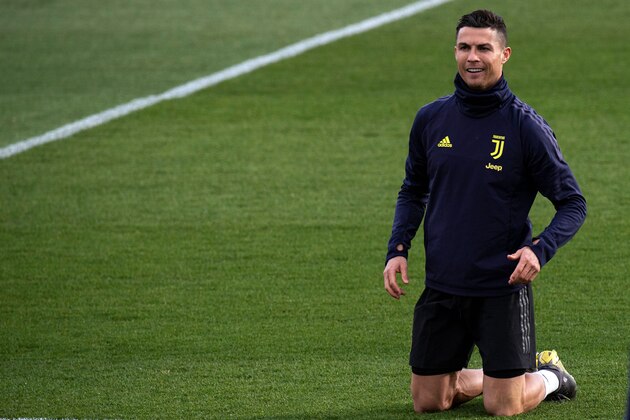 Juventus' Portuguese forward Cristiano Ronaldo kneels down during a training session on the eve of the UEFA Champions League football match Juventus vs Atletico Madrid, on March 11, 2019 at the 'Juventus Training Center' in Turin. (Photo by MARCO BERTORELLO / AFP)        (Photo credit should read MARCO BERTORELLO/AFP/Getty Images)